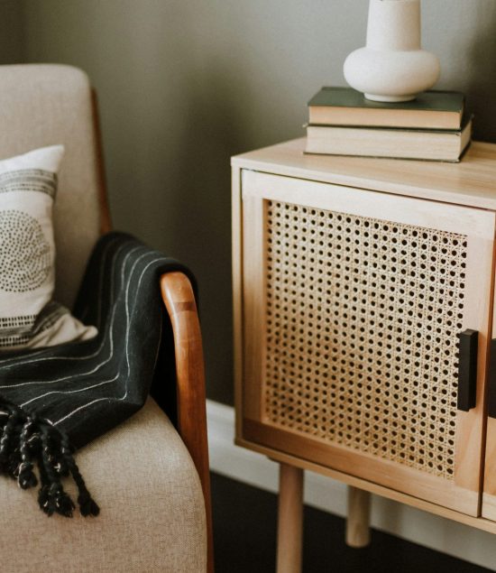 Cosy living room corner with books, neutral décor and soft furnishings